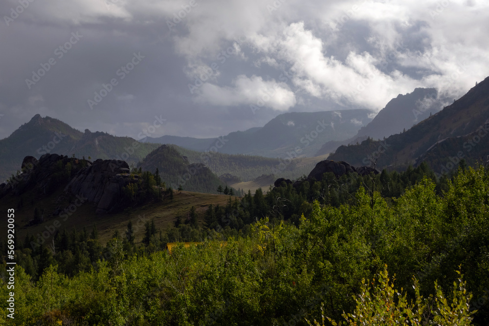 Terelj national park landscape, mountain ridge in Mongolia. Overview of the valley with the dramatic sky in the background.