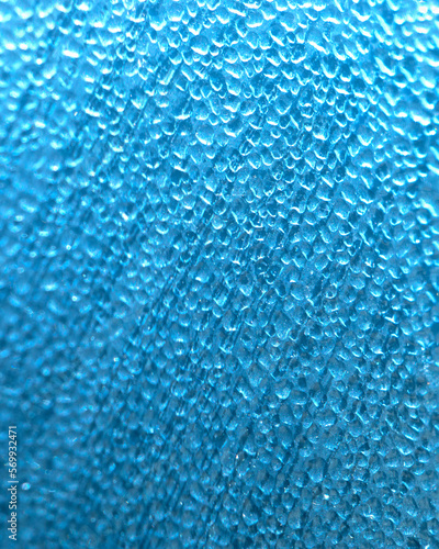 Raindrops on glass, blue background