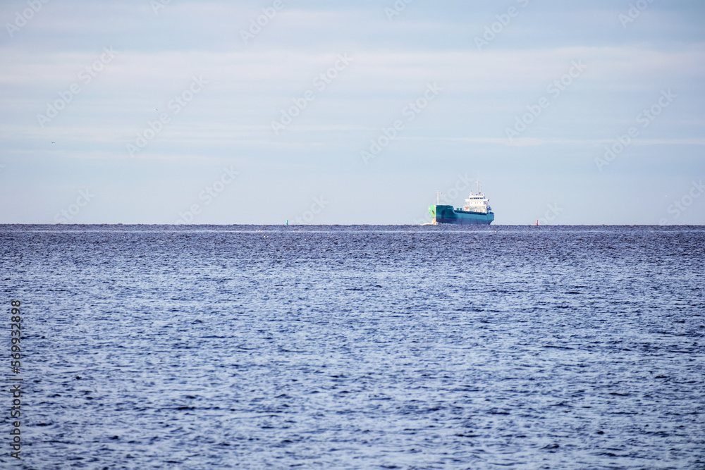Distant view with a ship in the sea with a blue sky