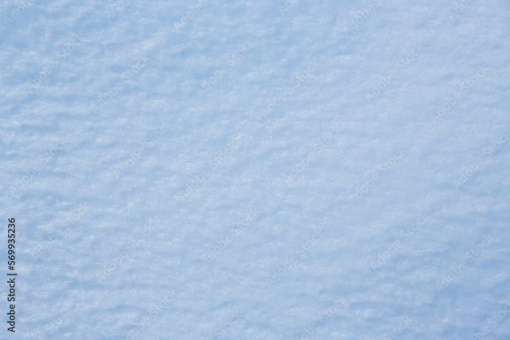 Fototapeta premium Natural snow texture. Smooth surface of clean fresh snow. Snowy ground. Winter background with snow patterns. Perfect for Christmas and New Year design. Closeup top view.