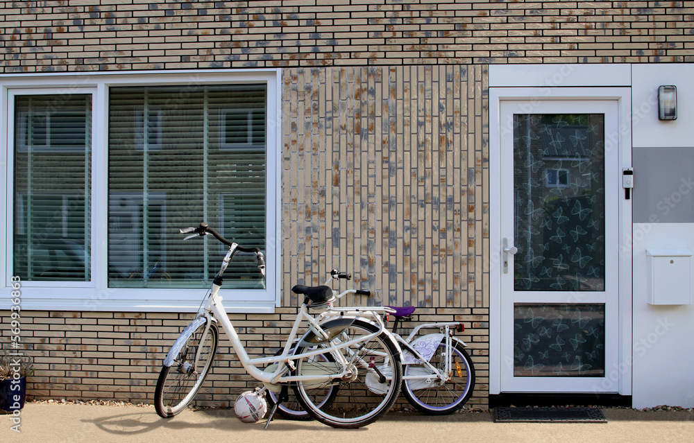 Front of Dutch family house with bicycles and football, Netherlands