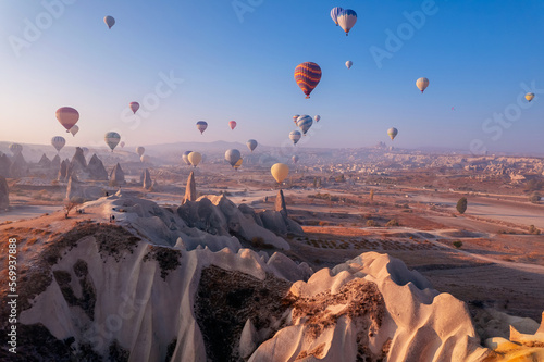 Travel tourist concept, Landscape sunrise with hot air balloons fly over deep canyons, valleys Cappadocia Goreme National Park Turkey