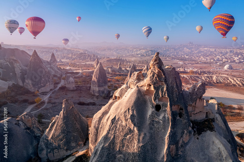 Travel tourist concept, Landscape sunrise with hot air balloons fly over deep canyons, valleys Cappadocia Goreme National Park Turkey