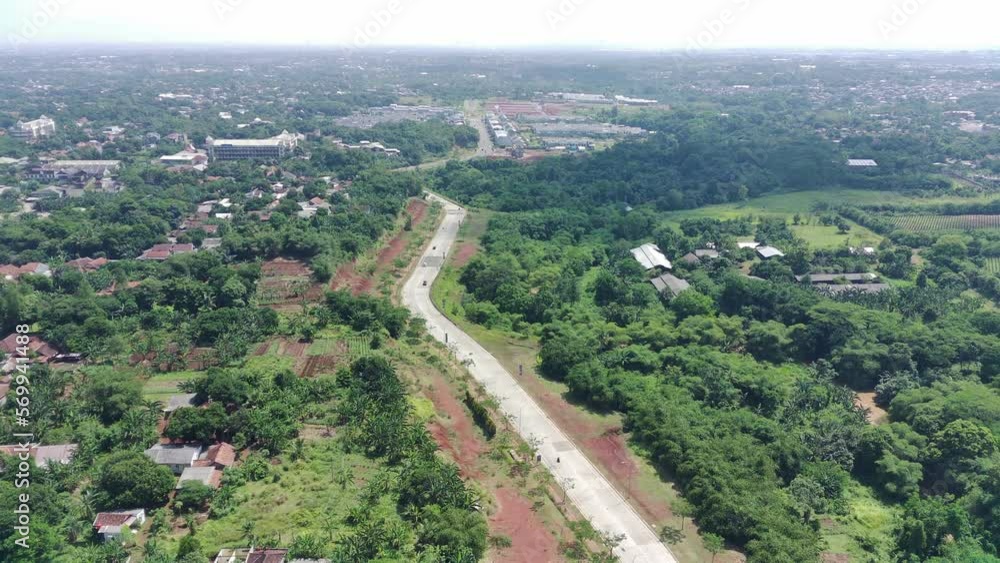 aerial view of the highway between greenery and residential areas. aerial view of the highway between greenery and residential areas.