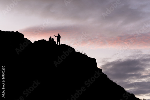 People silhouette on top of the hill