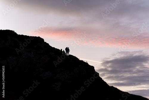 People silhouette on top of the hill