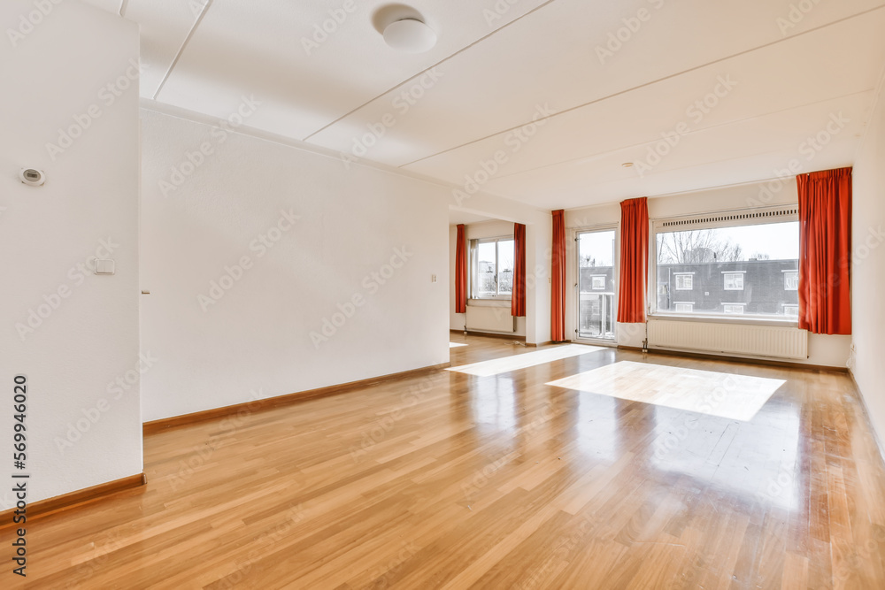 Spacious room with curtains on windows Spacious room with curtains on windows