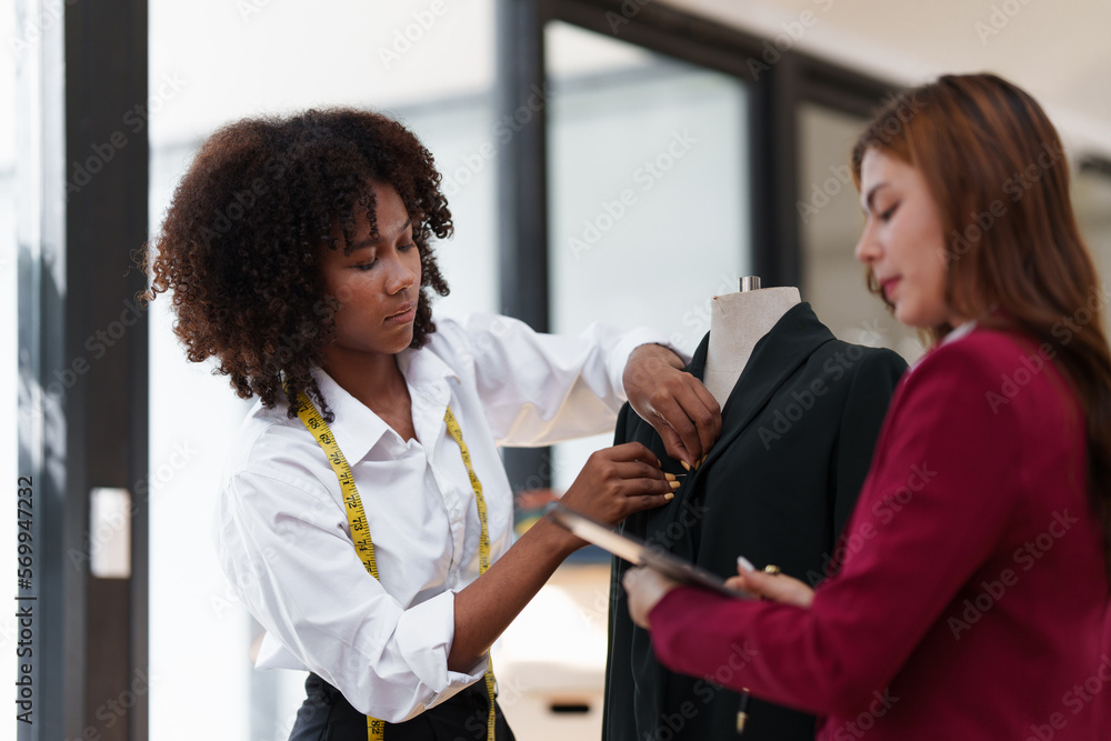 Obraz premium Portrait of young african american woman fashion designer stylish and friend working at fashion studio.