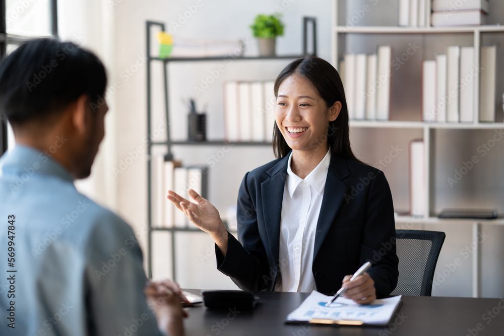Young smart businesswoman explaining her ideas of the project to her male coworker at the office. Young smart businesswoman explaining her ideas of the project to her male coworker at the office.