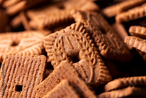 A portrait of a stack of brown cookies called speculaas or speculoos in Belgium or the Netherlands. The spiced biscuit is very delicious and popular during the winter period to be eaten at any time.