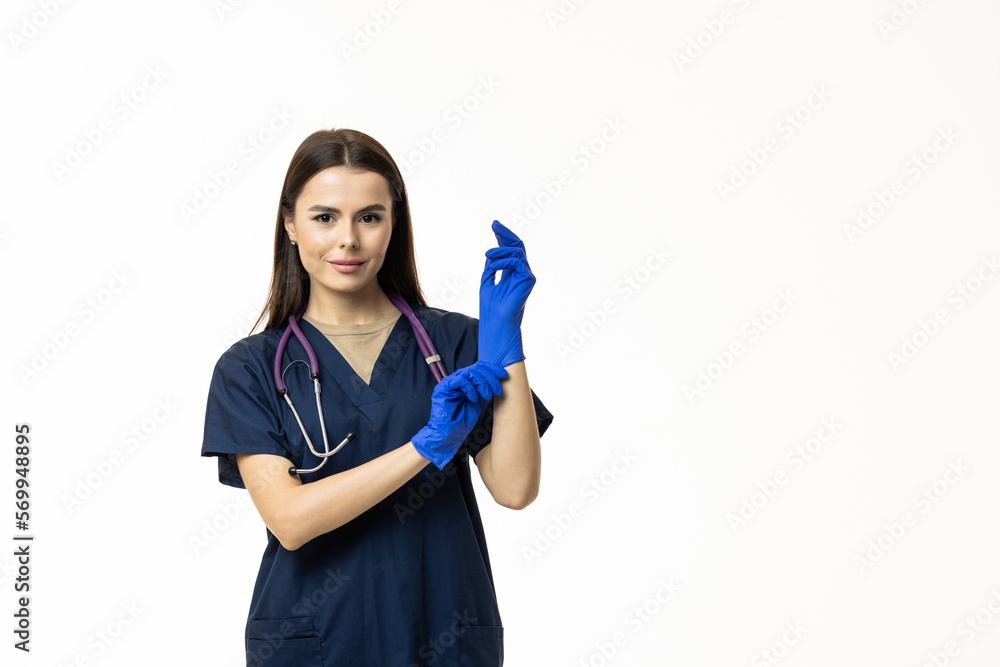 Young Woman in protective mask and glasses putting on medical glove against white background Young Woman in protective mask and glasses putting on medical glove against white background