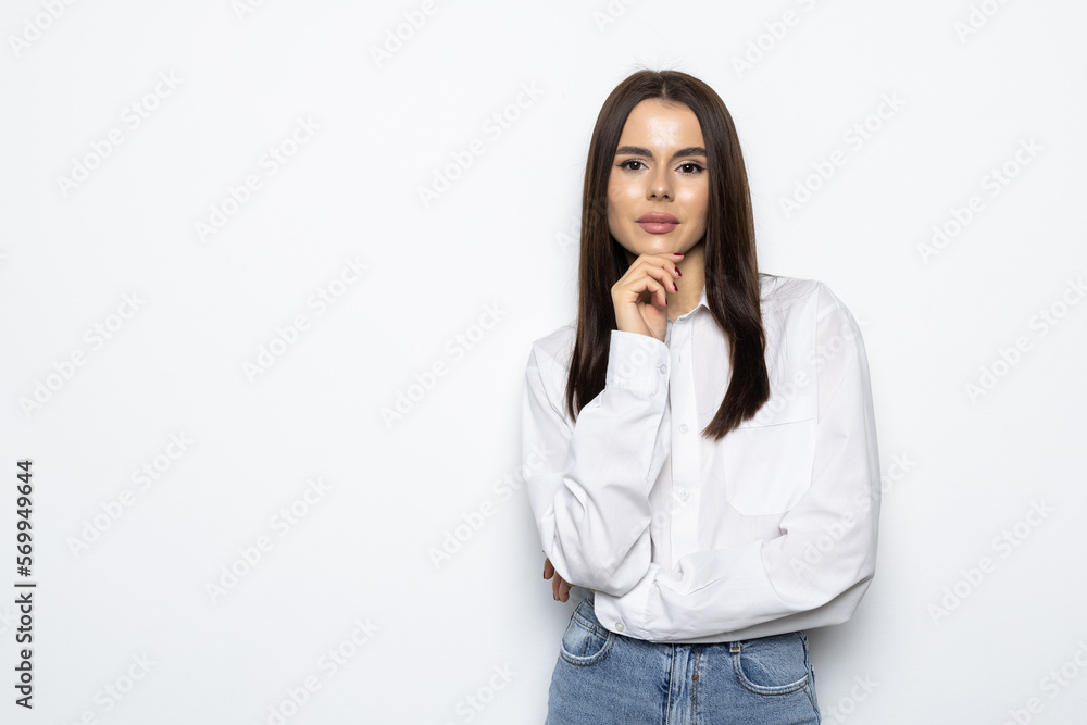 Smiling woman in eyeglasses posing with crossed arms and looking at the camera over white background Smiling woman in eyeglasses posing with crossed arms and looking at the camera over white background
