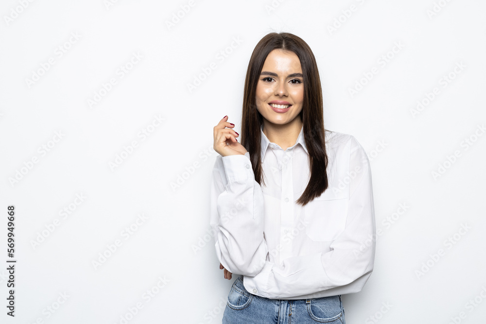 Smiling woman in eyeglasses posing with crossed arms and looking at the camera over white background Smiling woman in eyeglasses posing with crossed arms and looking at the camera over white background