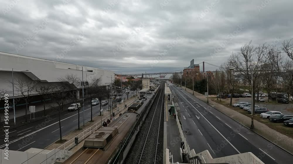 Overpass on Belém train station in Lisbon, with road traffic, and train moving out of the station Overpass on Belém train station in Lisbon, with road traffic, and train moving out of the station