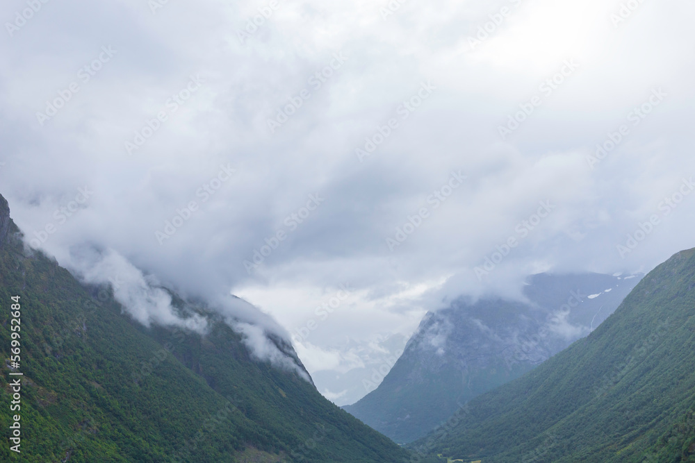 Panoramic view of mountain peaks in the clouds