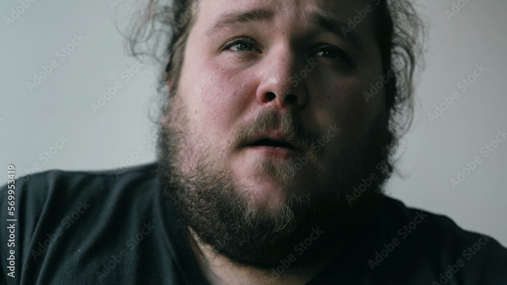 Preoccupied man suffering from mental pain. Close up face of a worried person with anxious expression. Emotional disorder concept Preoccupied man suffering from mental pain. Close up face of a worried person with anxious expression. Emotional disorder concept