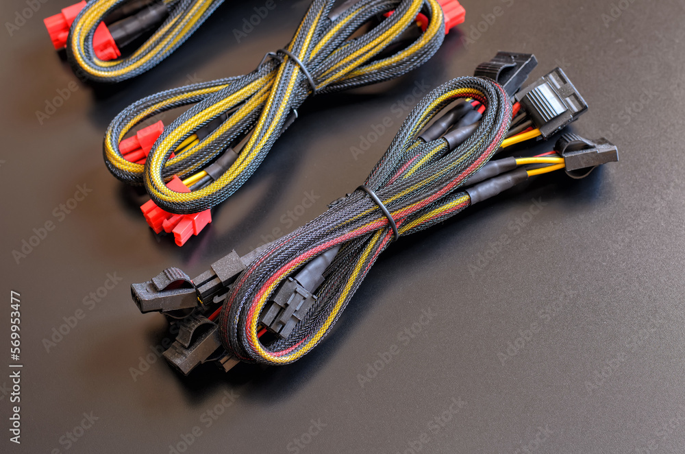 Three sets (bundles) of wires (cables) that connect PC power supply to the motherboard, video