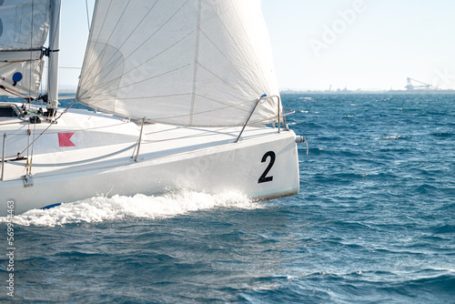Sailboat under white sails during the regatta competition