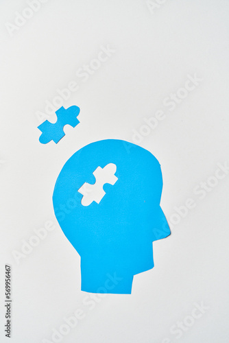 Alzheimer's disease, senile dementia and memory loss. Head silhouette with jigsaw puzzle photo