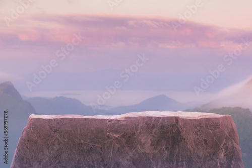 Stone podium table top on with outdoor mountains pastel color scene nature landscape at sunrise blur background.Natural beauty cosmetic or healthy product placement presentation pedestal display.