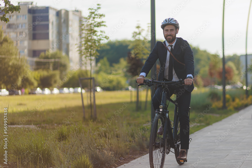 Happy man in black suit riding on bike on paved road. Happy man in black suit riding on bike on paved road.