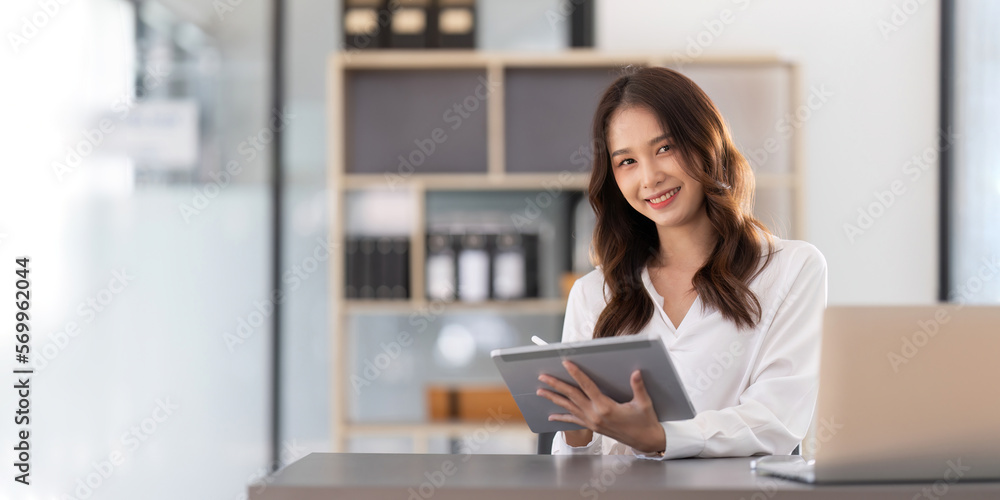 Young businesswoman working on laptop in office Young businesswoman working on laptop in office