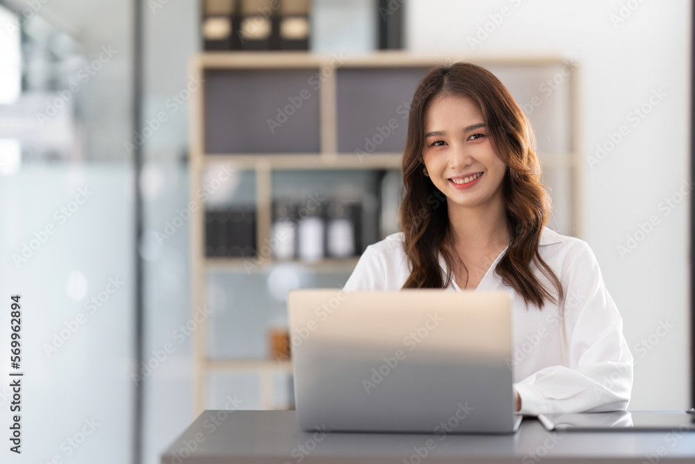 Young businesswoman working on laptop in office Young businesswoman working on laptop in office