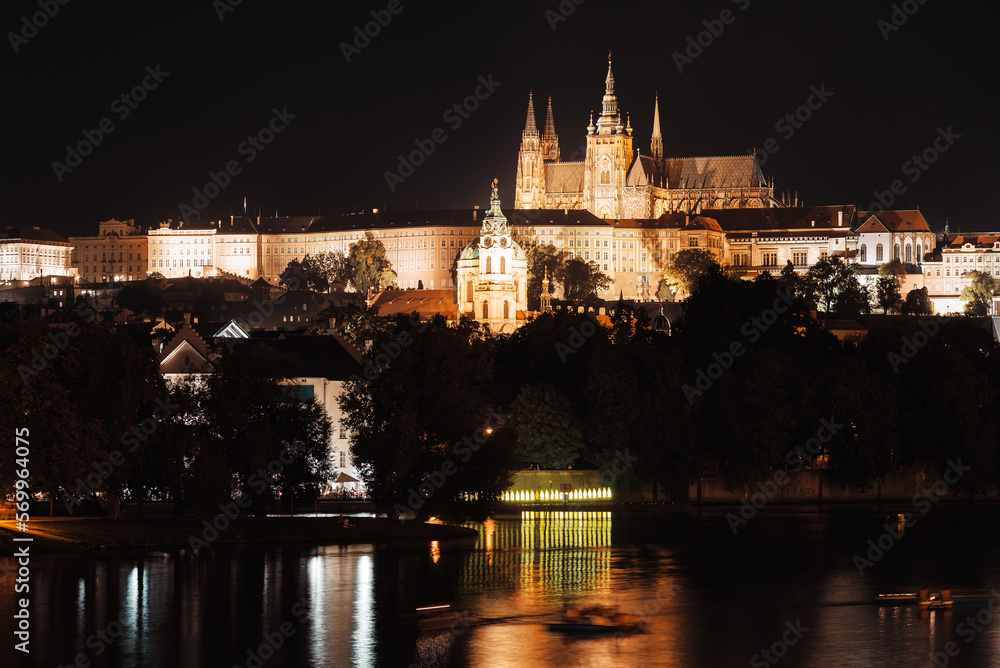Night view of Prague Castle and st. Vitus cathedral over Vltava river