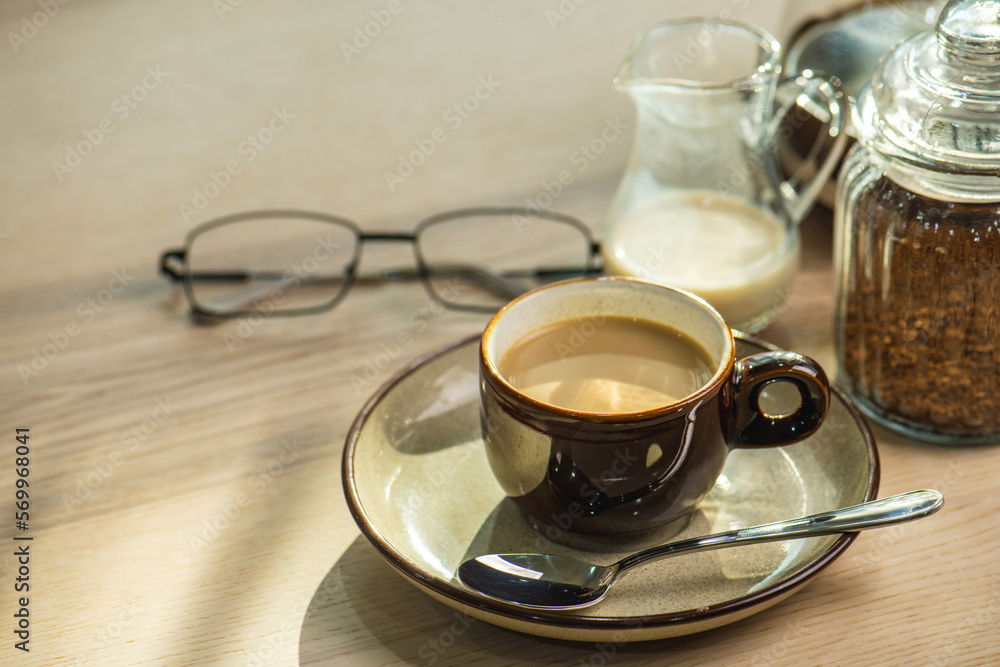 cup of hot Instant coffee dark shot in cup with crema on wooden table and beans . coffee beans and cup full of Intense dark shot coffee in glass cup cup of hot Instant coffee dark shot in cup with crema on wooden table and beans . coffee beans and cup full of Intense dark shot coffee in glass cup