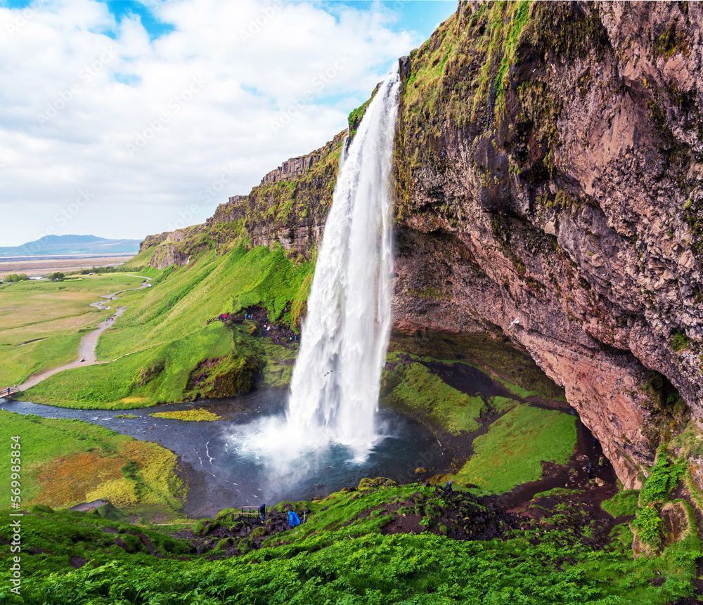 Charming beautiful waterfall Seljalandsfoss in Iceland. Exotic countries. Amazing places. Popular tourist atraction.