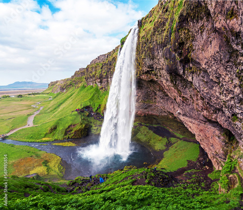 Charming beautiful waterfall Seljalandsfoss in Iceland. Exotic countries. Amazing places. Popular tourist atraction.