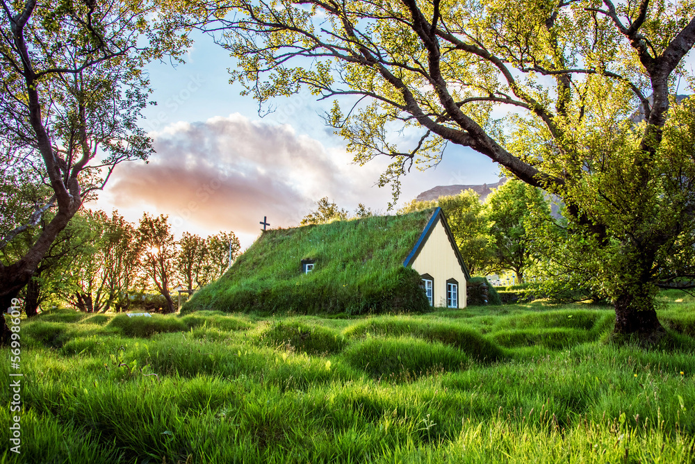 Charming mystical scene with turf roof church in old Iceland traditional style and mystical cemetery in Hof, Skaftafell, Vatnajokull National Park. Exotic countries.