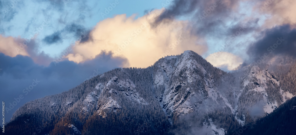 North Shore Mountains Covered in Snow and Clouds. North Vancouver, British Columbia, Canada. Nature Background. Sunset