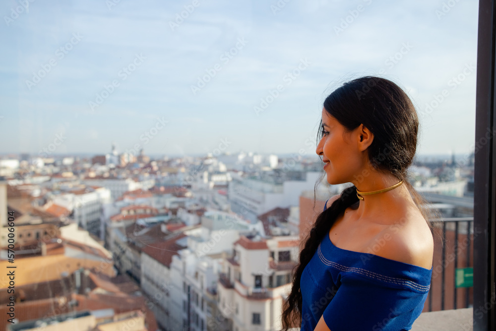 Woman admiring city from balcony