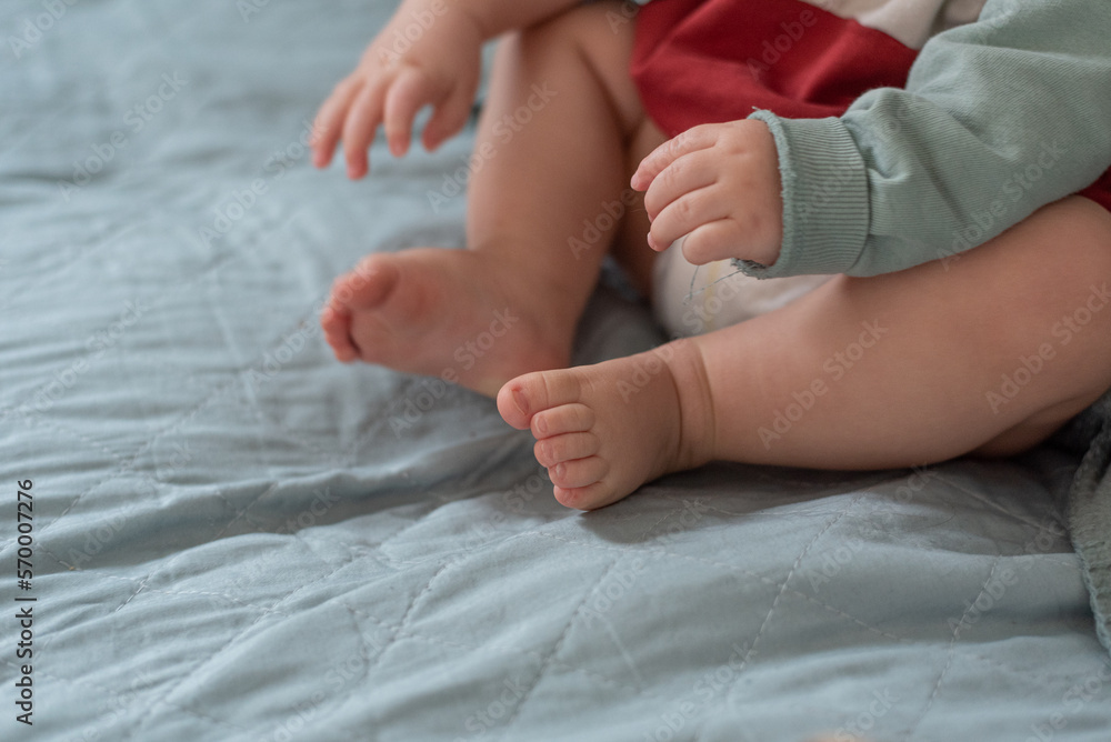 sweet baby feet and hands in bed with space for design, background. sweet baby feet and hands in bed with space for design, background.