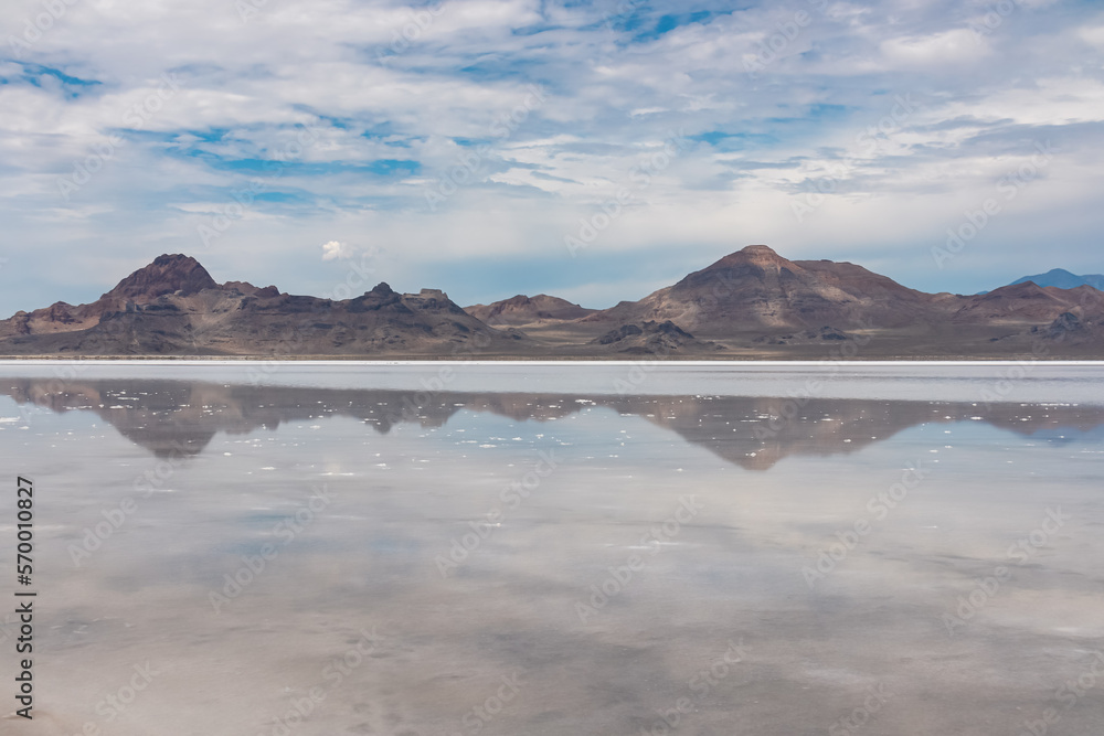 Panoramic view of beautiful mountain reflecting in lake of Bonneville Salt Flats, Wendover, Western Utah, USA, America. Looking at summits of Silver Island Mountains range. West of Great Salt Lake