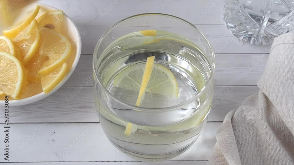 Water in a glass and lemon juice. Preparation of a tonic soft drink. Water in a glass and lemon juice. Preparation of a tonic soft drink.