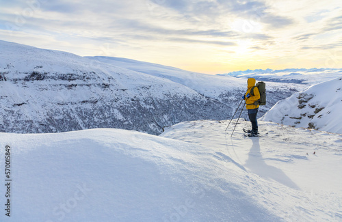 Snow shoe hiking on a beautiful sunny day at a mountain peak of Dovrefjell © kjekol