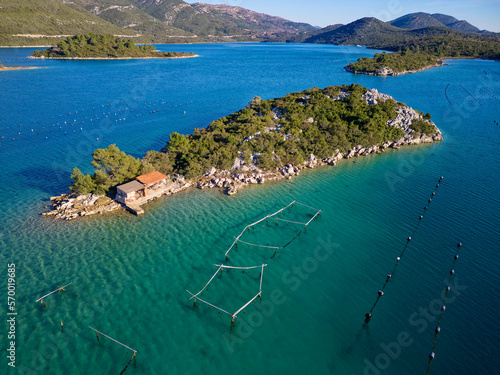 Aerial drone view of the bay of Mali Ston located on Peljesac peninsula. Oyster farms in the turquoise sea water. Unique mix of freshwater and seawater.