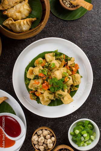 Tahu goreng Cabe Garam or Crispy Salt and Pepper Tofu served on white plate photo