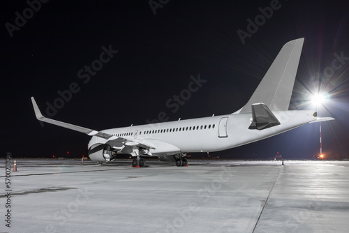 Modern passenger airliner on the night airport apron