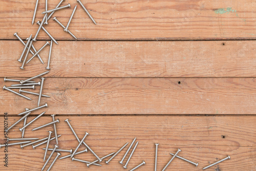 Wooden background with metal screws