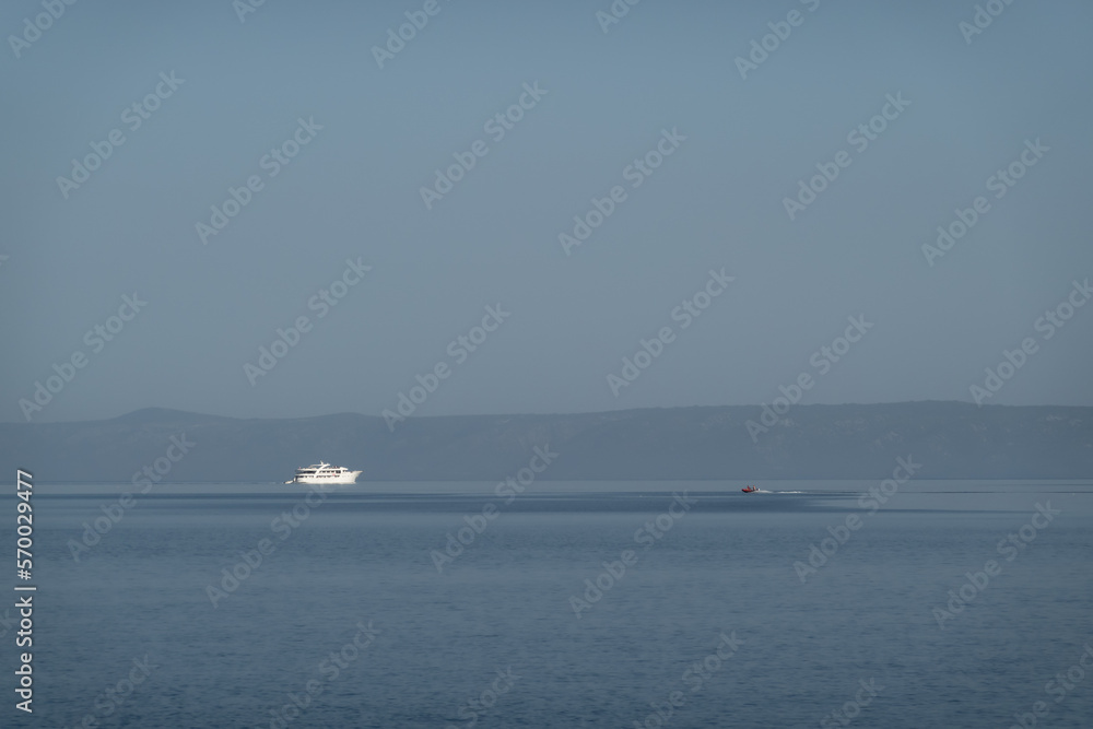Luxury motor yacht on the horizon of calm sea
