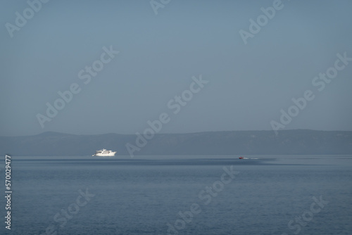 Luxury motor yacht on the horizon of calm sea