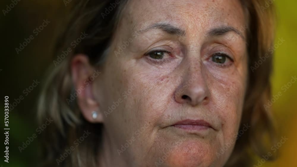 Close up face of a senior woman with pensive expression. Thoughtful concerned older female person in 70s with serious emotion Close up face of a senior woman with pensive expression. Thoughtful concerned older female person in 70s with serious emotion