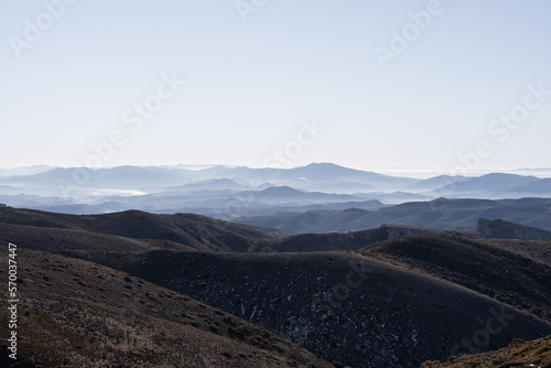 A landscape mountainous view with a lot of layers and deep of field and fog on the top