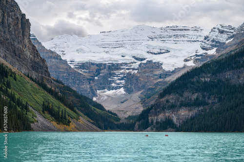 Panoramic image of Lake Louise (Canada) in summer, with crystal blue water and snow on the mountains in the background.