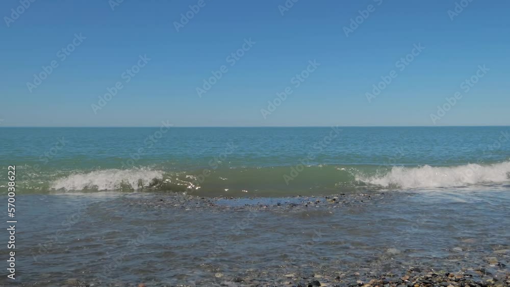 Slow motion - sea water waves are crashing on the pebble beach. Nature and relaxation concept Slow motion - sea water waves are crashing on the pebble beach. Nature and relaxation concept