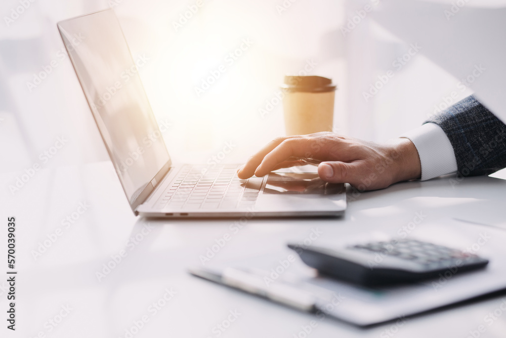 Fototapeta premium Asian Business woman using calculator and laptop for doing math finance on an office desk, tax, report, accounting, statistics, and analytical research concept