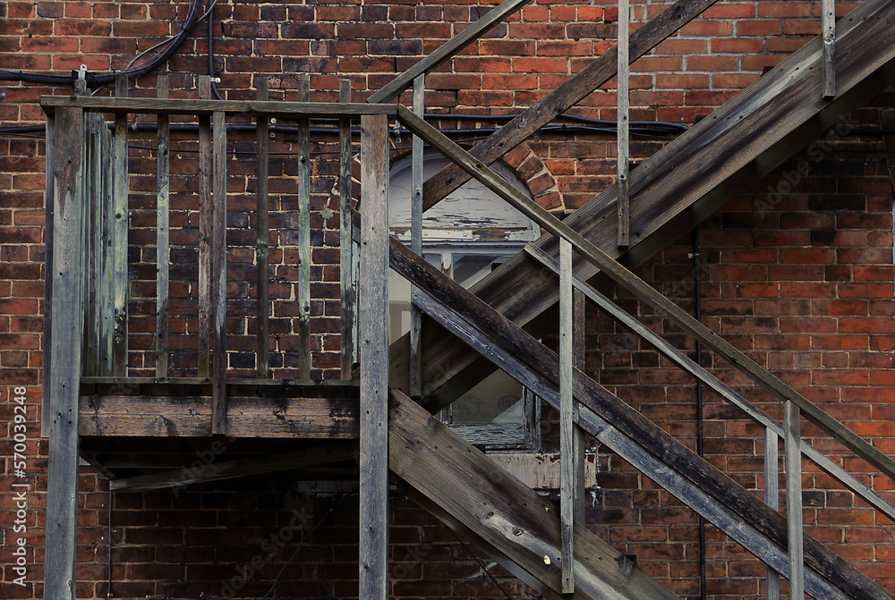 OLD  WOODEN FIRE ESCAPE ON BRICK BUILDING